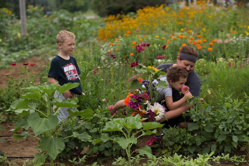 Family outdoors picking flowers together